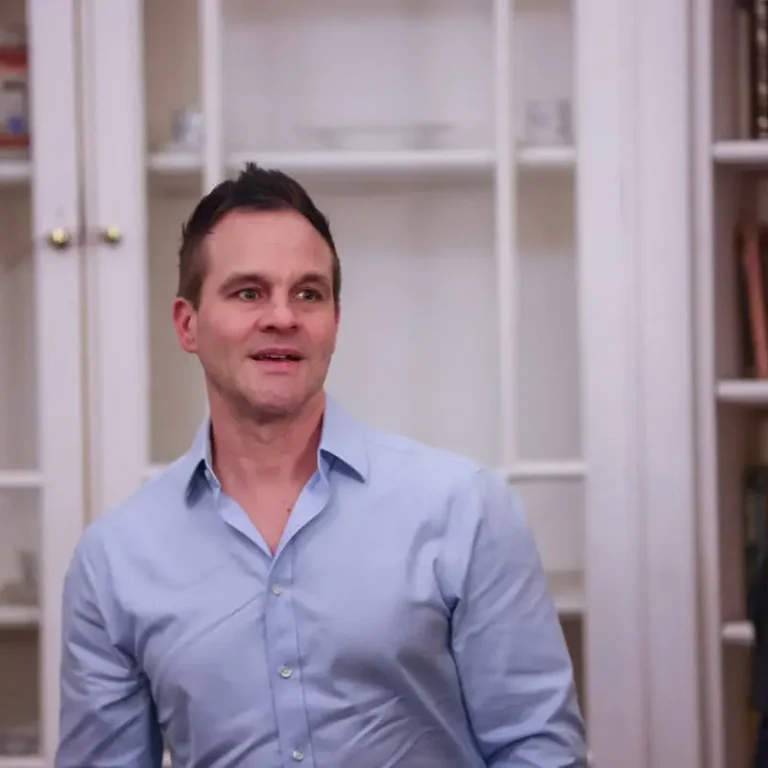 man-posing-book-case